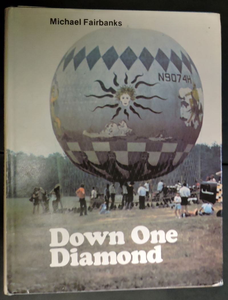 Colour pictorial cover of book showing netted gas balloon fully inflated on the ground awaiting attachment of basket